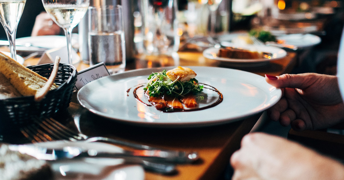 Plate of food at restaurant. Mindful eating: The 8 types of hunger.