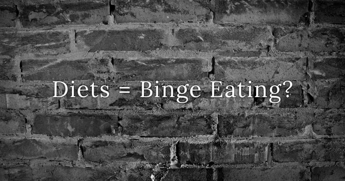 Word: Diets = Binge Eating? over brick wall.